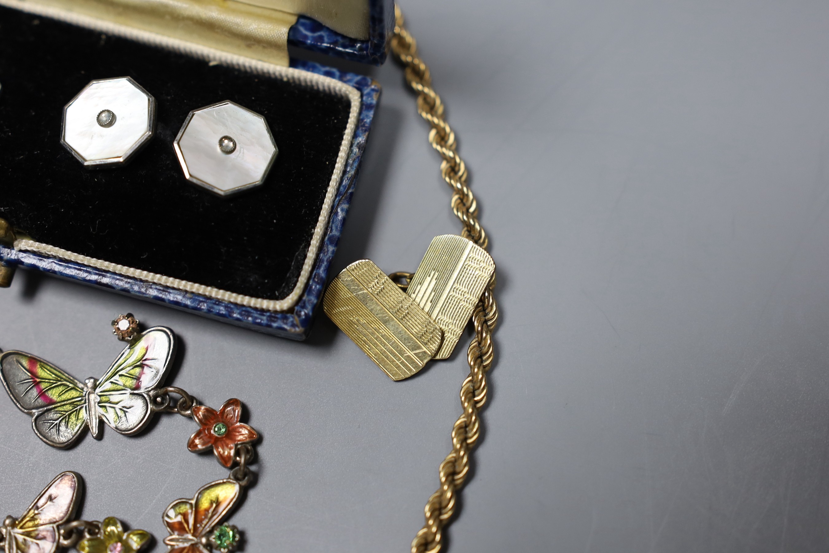 A modern 9ct gold rope twist chain, 5.2 grams, a white metal and enamel butterfly link bracelet, a pair of mother of pearl and base metal cufflinks in box, a gold plated cufflink and a silver dress ring.